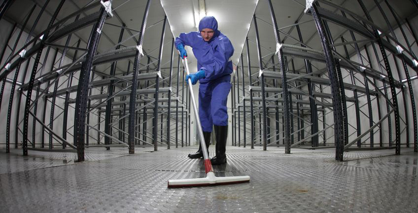 Worker cleaning an industrial floor